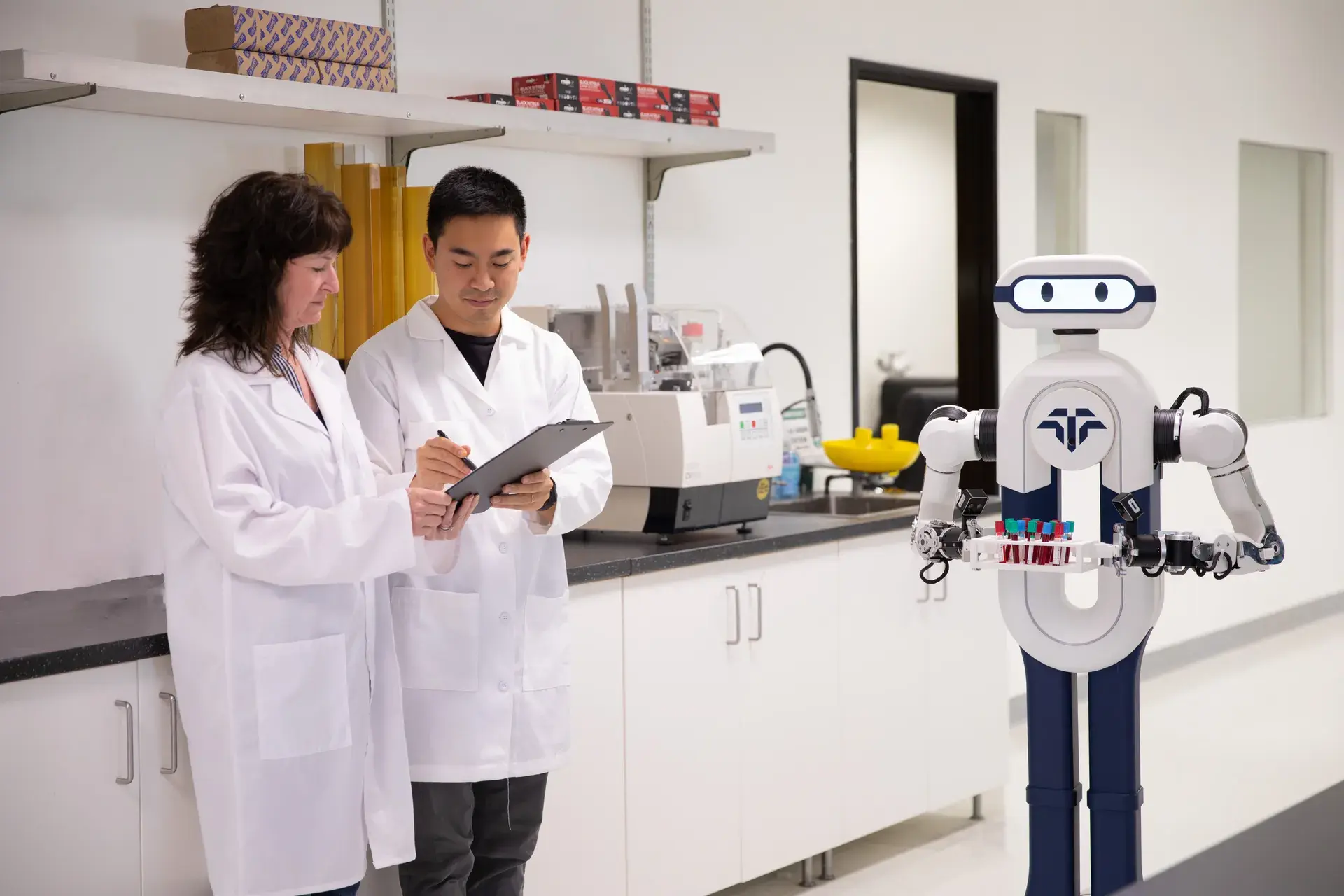 Tactus AI robot working alongside lab technicians