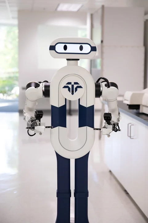 The Tactus AI humanoid robotic lab assistant working in a laboratory