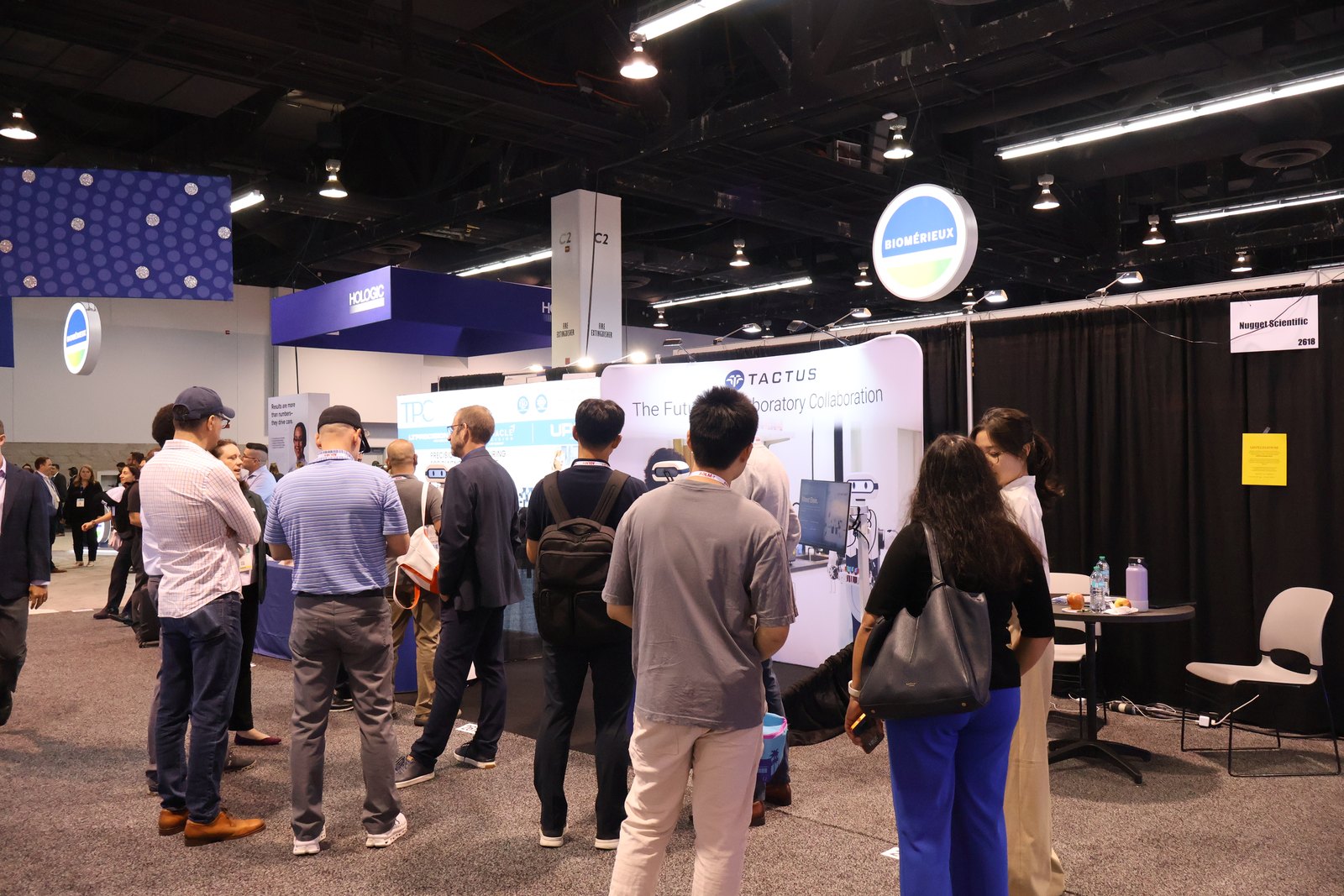 Attendees gathered several deep at the Tactus AI booth on the ADLM 2026 exhibition floor in Anaheim